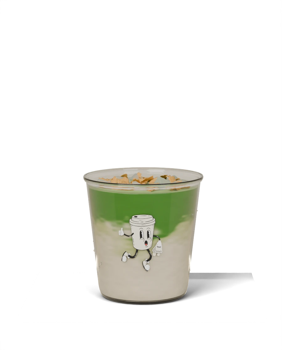 Cereal Milk Matcha with golden cereal flakes in a clear Brewch cup with a rounded heel.