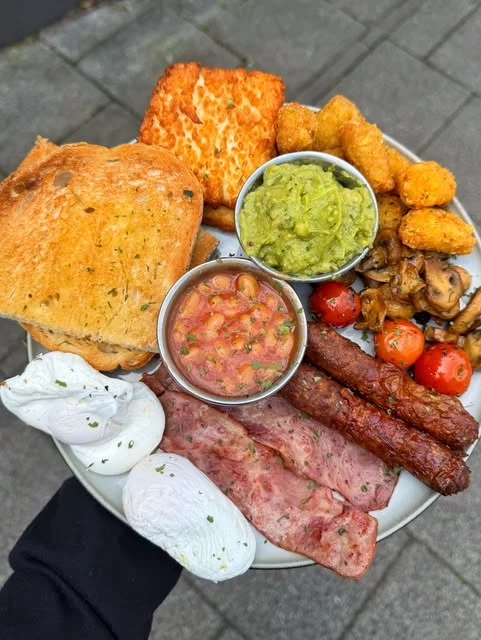 A Brewch breakfast plate with eggs, toast, hash browns and avocado.