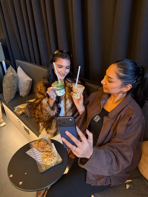 Brunch and iced drinks shared at a Brewch table.